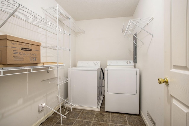 laundry area featuring separate washer and dryer and baseboards