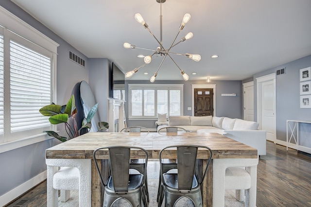 dining space featuring a chandelier, baseboards, dark wood-type flooring, and recessed lighting