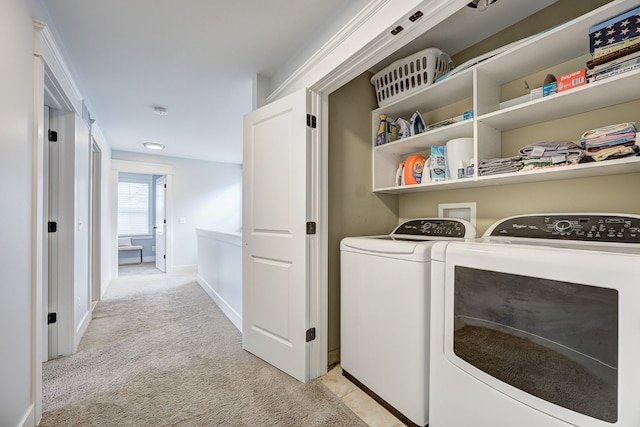 laundry room with separate washer and dryer, light colored carpet, and baseboards