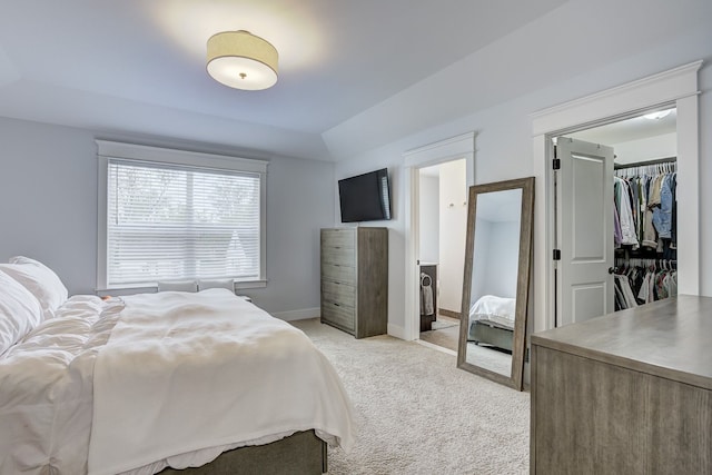 bedroom with light colored carpet and baseboards