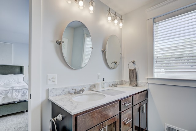 bathroom with ensuite bathroom and double vanity