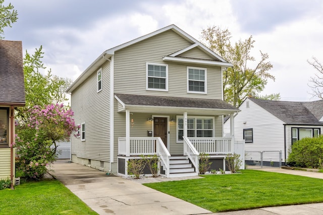 view of front facade featuring covered porch and a front lawn