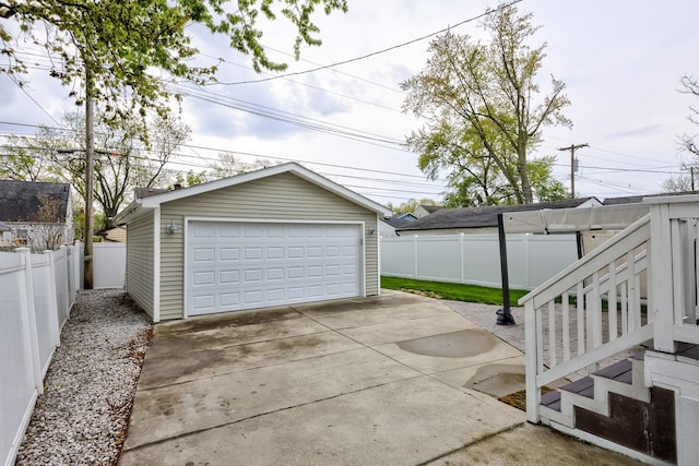 detached garage featuring fence