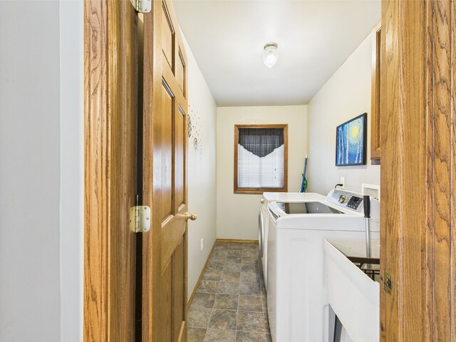 480 Peninsula Dr, Columbiaville, MI 48421 - clothes washing area featuring washer and dryer, stone finish flooring, and baseboards