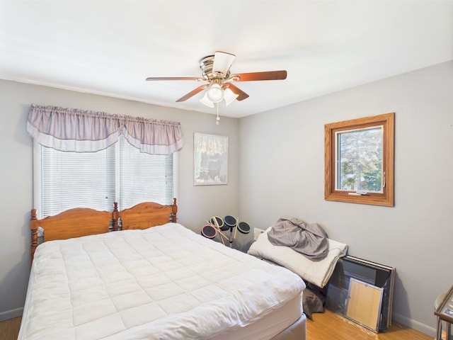480 Peninsula Dr, Columbiaville, MI 48421 - bedroom featuring wood finished floors, baseboards, and a ceiling fan