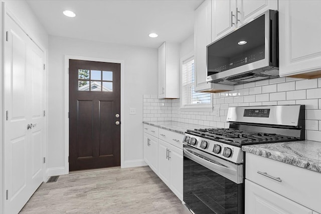 1132 Superior Blvd, Wyandotte, MI 48192 - kitchen featuring stainless steel appliances, light stone countertops, white cabinetry, and recessed lighting