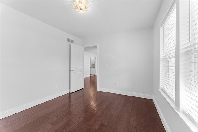 1132 Superior Blvd, Wyandotte, MI 48192 - unfurnished room featuring plenty of natural light, dark wood-type flooring, and baseboards