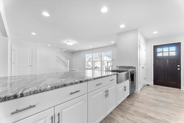 1132 Superior Blvd, Wyandotte, MI 48192 - kitchen featuring a sink, light stone counters, white cabinetry, recessed lighting, and baseboards
