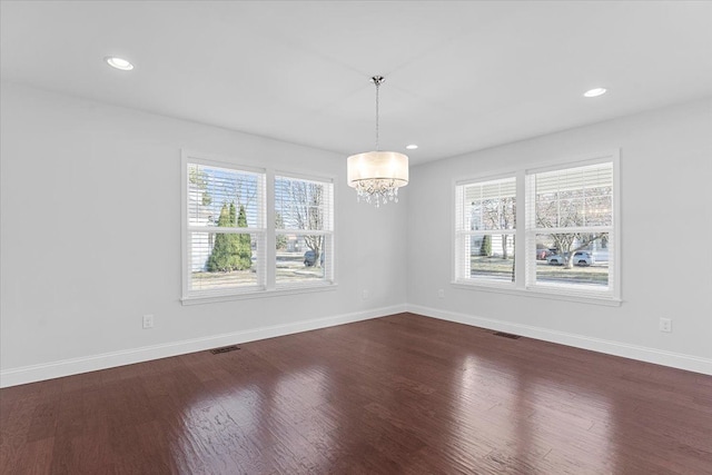 1132 Superior Blvd, Wyandotte, MI 48192 - empty room with healthy amount of natural light, dark wood finished floors, a chandelier, and recessed lighting