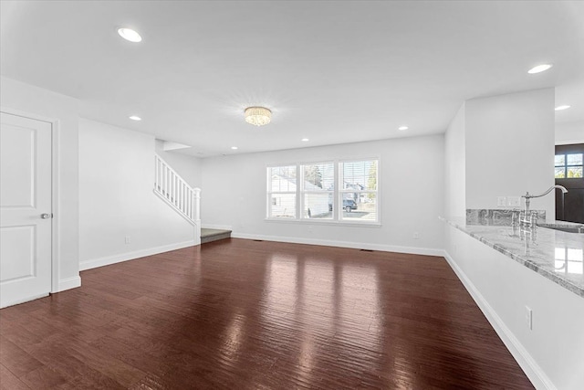 1132 Superior Blvd, Wyandotte, MI 48192 - unfurnished living room with stairway, dark wood-style floors, a sink, recessed lighting, and baseboards