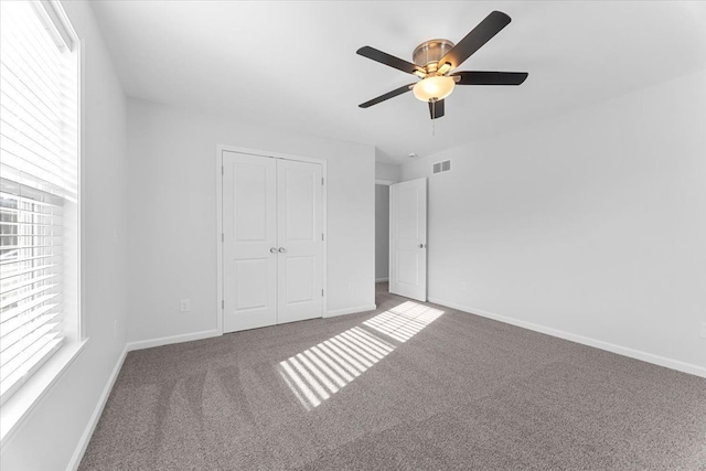 1132 Superior Blvd, Wyandotte, MI 48192 - unfurnished bedroom with carpet flooring, multiple windows, a closet, and baseboards
