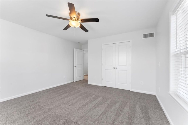 1132 Superior Blvd, Wyandotte, MI 48192 - unfurnished bedroom with carpet flooring, a closet, multiple windows, and baseboards