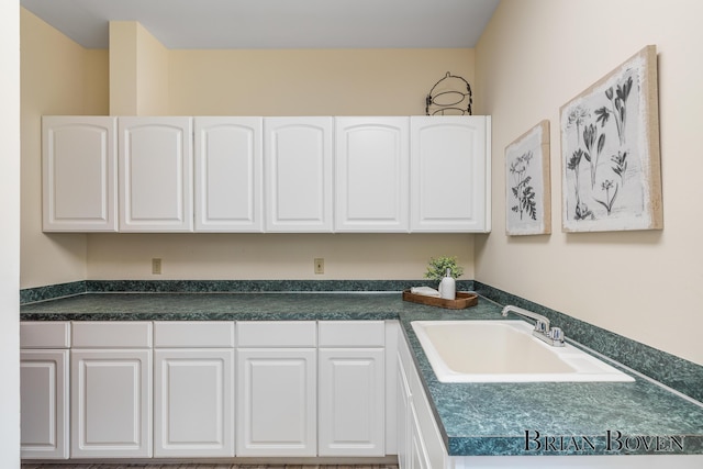 7620 Spring Point Ct NE, Rockford, MI 49341 - kitchen featuring white cabinetry, a sink, and dark countertops