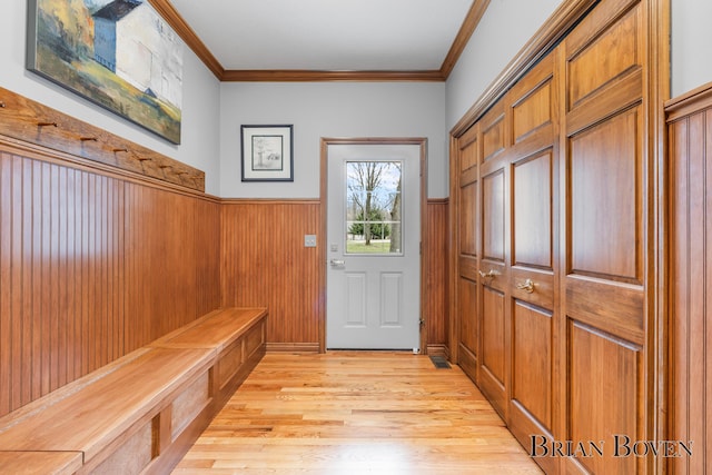 7620 Spring Point Ct NE, Rockford, MI 49341 - mudroom featuring a wainscoted wall, ornamental molding, light wood-type flooring, and wooden walls