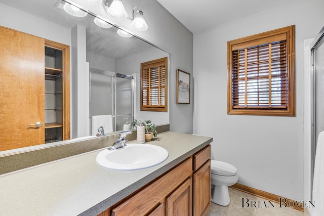 7620 Spring Point Ct NE, Rockford, MI 49341 - bathroom with a stall shower, tile patterned floors, vanity, toilet, and baseboards