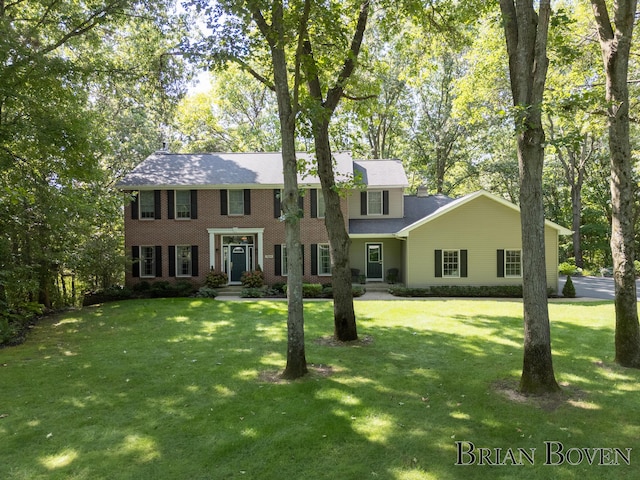 7620 Spring Point Ct NE, Rockford, MI 49341 - colonial-style house featuring a front yard and brick siding