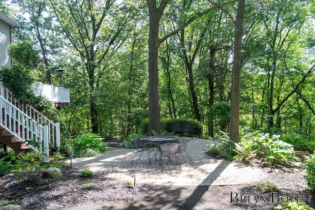 7620 Spring Point Ct NE, Rockford, MI 49341 - view of yard featuring a patio area, stairs, and outdoor dining space