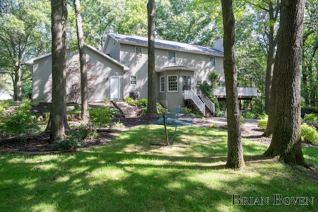 7620 Spring Point Ct NE, Rockford, MI 49341 - rear view of property with stairway, a deck, a chimney, and a lawn