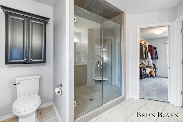7620 Spring Point Ct NE, Rockford, MI 49341 - full bath featuring a stall shower, tile patterned floors, toilet, and a walk in closet
