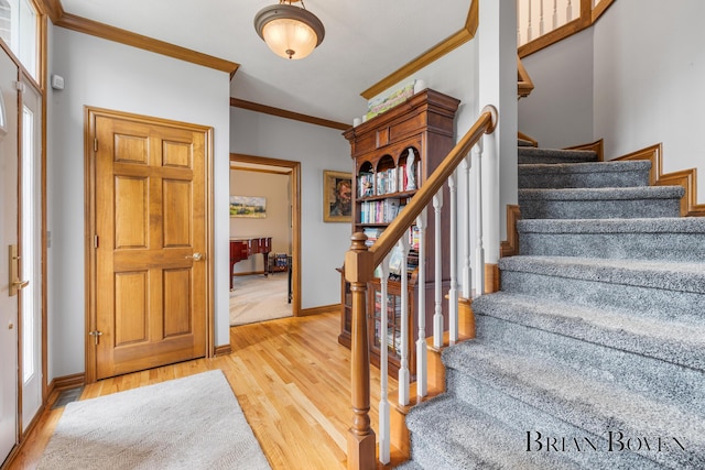 7620 Spring Point Ct NE, Rockford, MI 49341 - entrance foyer with ornamental molding, wood finished floors, baseboards, and stairway