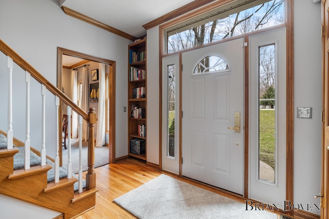 7620 Spring Point Ct NE, Rockford, MI 49341 - entrance foyer featuring stairway, light wood-style floors, and crown molding