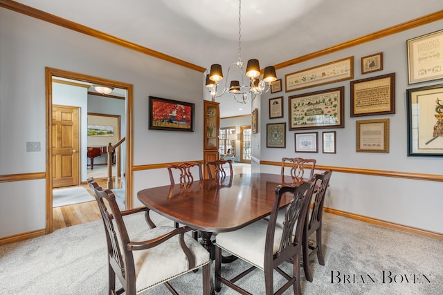 7620 Spring Point Ct NE, Rockford, MI 49341 - dining space featuring light colored carpet, baseboards, ornamental molding, and a chandelier