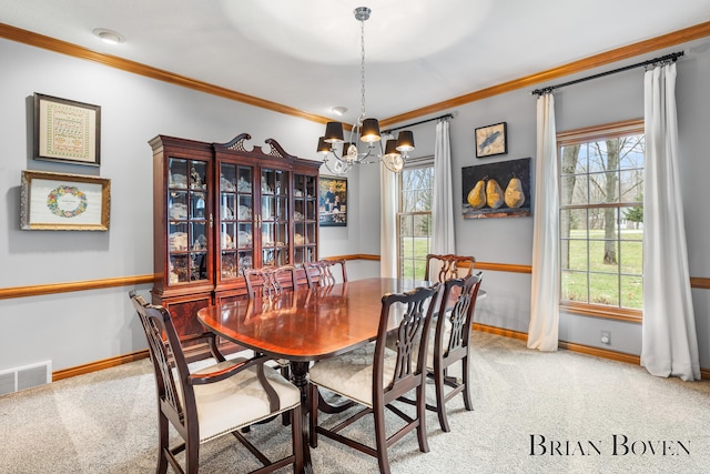 7620 Spring Point Ct NE, Rockford, MI 49341 - dining room featuring a chandelier, light carpet, baseboards, crown molding, and plenty of natural light