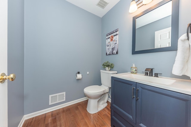 661 Morning Glory Ln, Milan, MI 48160 - bathroom featuring wood finished floors, baseboards, toilet, and vanity