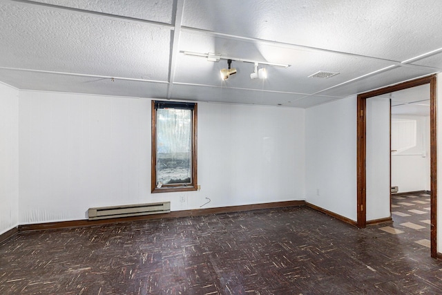 721 W Washington St, Ann Arbor, MI 48103 - basement featuring a baseboard radiator, baseboards, and a textured ceiling