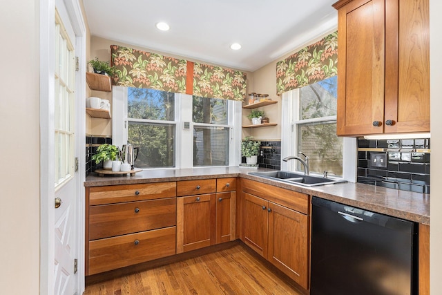 721 W Washington St, Ann Arbor, MI 48103 - kitchen with black dishwasher, a sink, open shelves, light wood finished floors, and brown cabinets