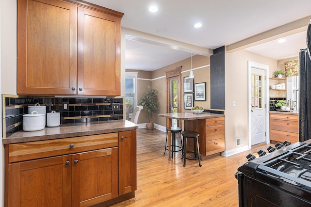 721 W Washington St, Ann Arbor, MI 48103 - kitchen with baseboards, decorative backsplash, light wood finished floors, and recessed lighting