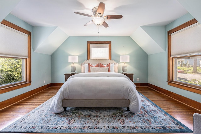 721 W Washington St, Ann Arbor, MI 48103 - bedroom featuring wood finished floors, multiple windows, baseboards, lofted ceiling, and a ceiling fan
