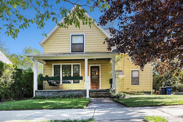 721 W Washington St, Ann Arbor, MI 48103 - view of front of house featuring covered porch and a front lawn