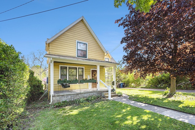 721 W Washington St, Ann Arbor, MI 48103 - view of front of house with covered porch and a front yard