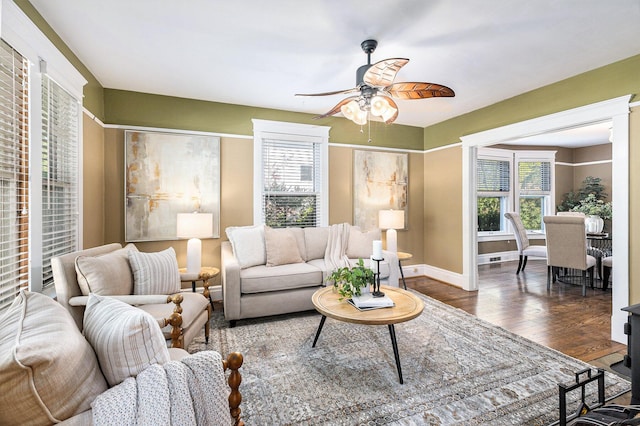 721 W Washington St, Ann Arbor, MI 48103 - living area featuring a ceiling fan, healthy amount of natural light, wood finished floors, and baseboards