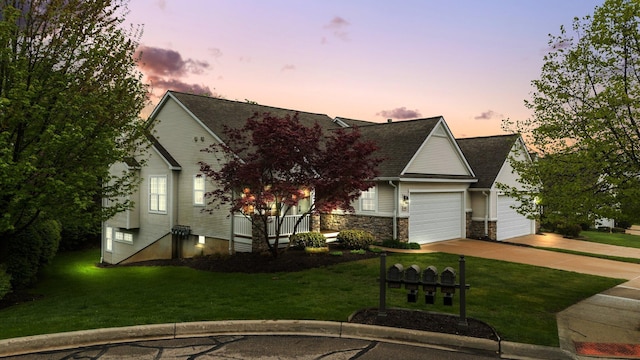 obstructed view of property featuring a yard, concrete driveway, an attached garage, a porch, and a shingled roof