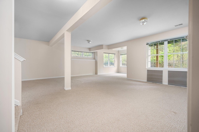 unfurnished living room featuring carpet flooring and baseboards