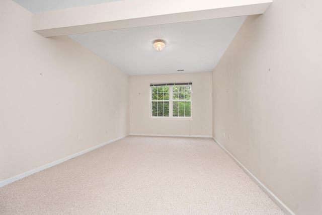 spare room with carpet and baseboards