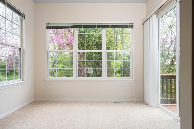 carpeted empty room with baseboards