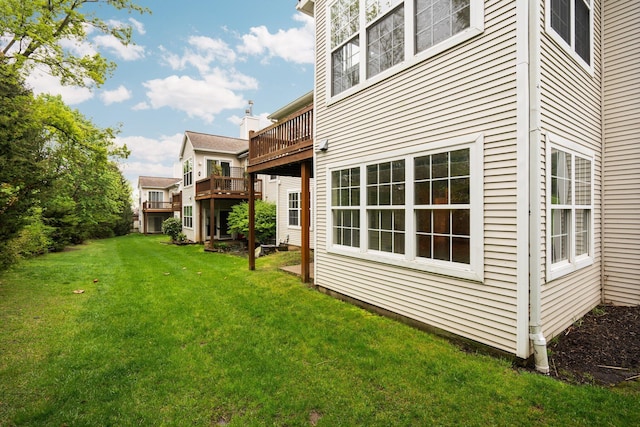 view of grassy yard featuring a deck