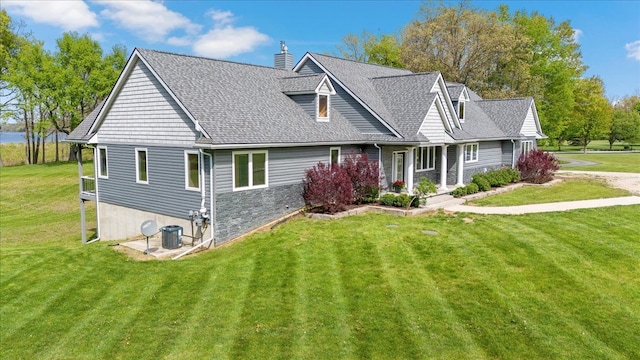 12150 Shaffer Rd, Davisburg, MI 48350 - view of front facade featuring a front yard, a chimney, roof with shingles, and central AC unit