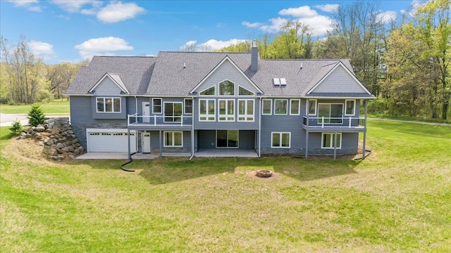 12150 Shaffer Rd, Davisburg, MI 48350 - rear view of property with a fire pit, a chimney, a yard, an attached garage, and a patio area