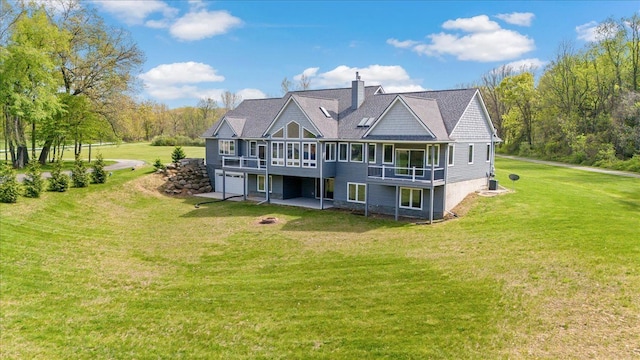 12150 Shaffer Rd, Davisburg, MI 48350 - rear view of property featuring a chimney, a yard, a garage, and a wooden deck