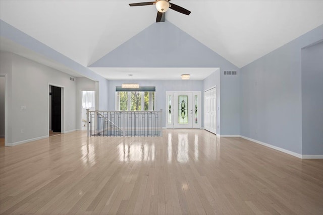 12150 Shaffer Rd, Davisburg, MI 48350 - unfurnished living room featuring ceiling fan, light wood-style flooring, baseboards, and high vaulted ceiling