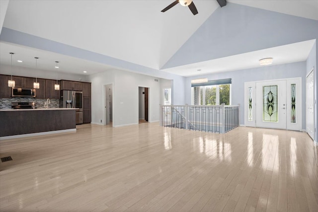 12150 Shaffer Rd, Davisburg, MI 48350 - unfurnished living room with ceiling fan, high vaulted ceiling, light wood-type flooring, a sink, and recessed lighting