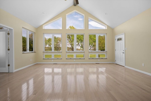 12150 Shaffer Rd, Davisburg, MI 48350 - unfurnished living room with light wood-style floors, healthy amount of natural light, baseboards, a ceiling fan, and beam ceiling