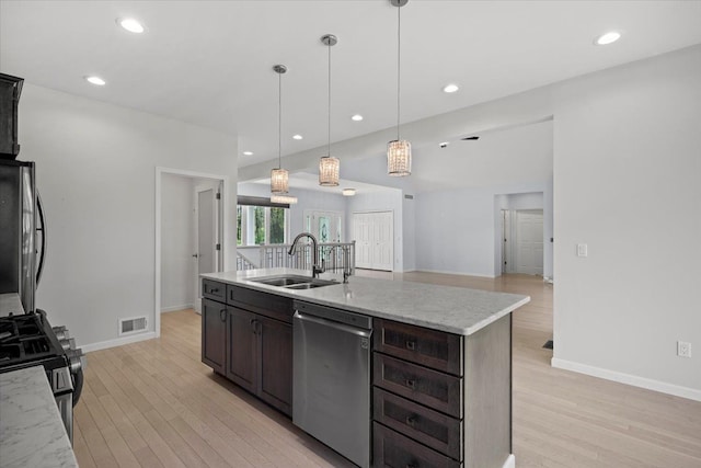 12150 Shaffer Rd, Davisburg, MI 48350 - kitchen with stainless steel appliances, a sink, light wood finished floors, dark brown cabinets, and recessed lighting