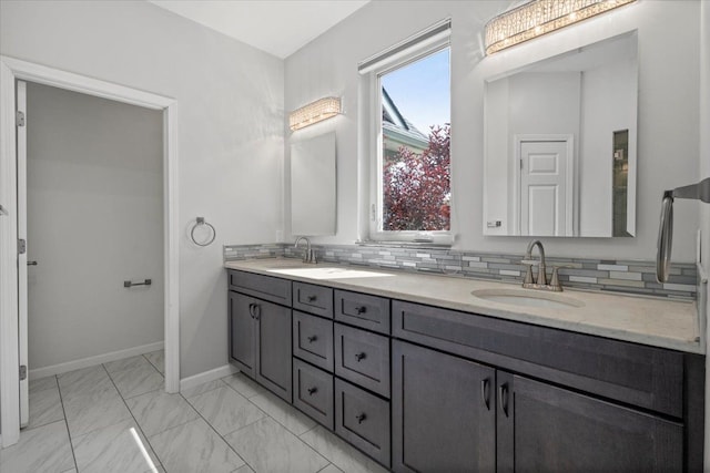 12150 Shaffer Rd, Davisburg, MI 48350 - bathroom featuring double vanity, baseboards, backsplash, and marble finish floors