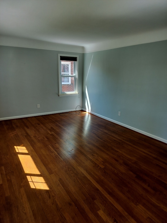 9909 Brookfield St, Livonia, MI 48150 - empty room with dark wood-style flooring and baseboards