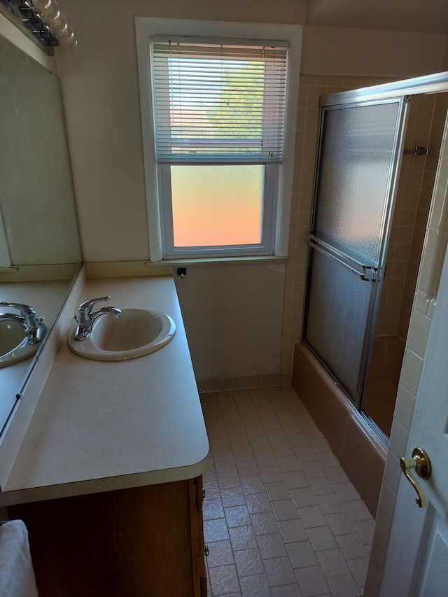 9909 Brookfield St, Livonia, MI 48150 - bathroom with tile patterned floors, vanity, and enclosed tub / shower combo